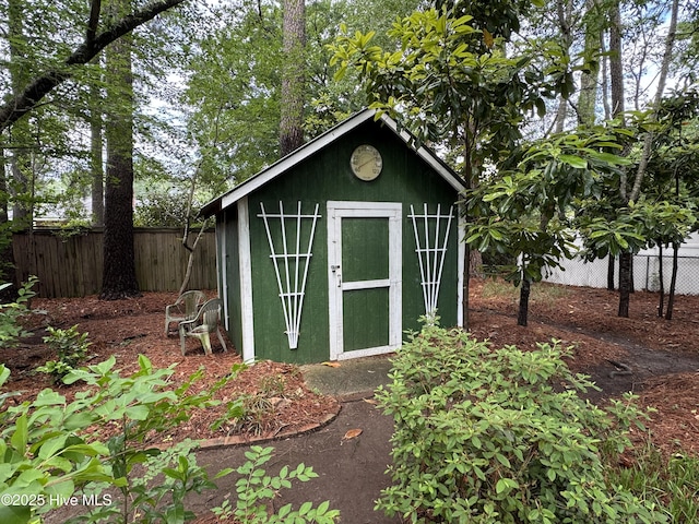 view of shed with fence