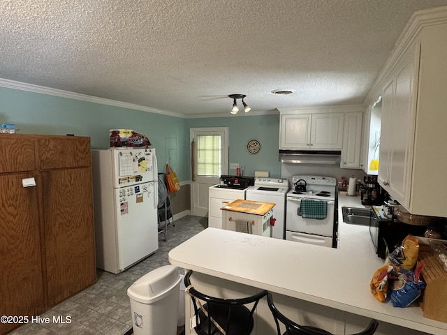 kitchen featuring white appliances, independent washer and dryer, ventilation hood, a peninsula, and crown molding