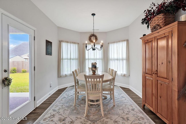 1592 E New Carraway Pl SE, Bolivia, NC 28422 - dining room with a chandelier, baseboards, and dark wood-style floors