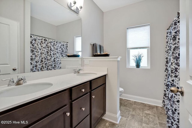 1592 E New Carraway Pl SE, Bolivia, NC 28422 - full bathroom featuring toilet, double vanity, baseboards, and a shower with shower curtain