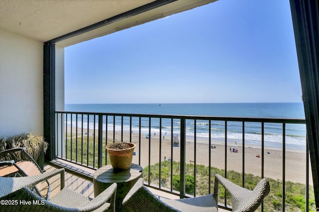 balcony featuring view of water and beach