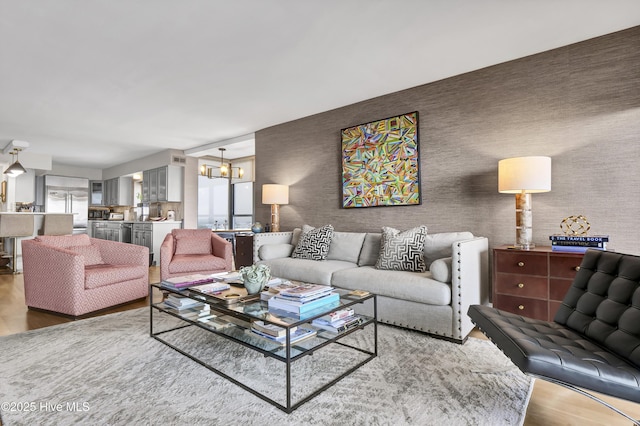 living area with wood finished floors and a chandelier