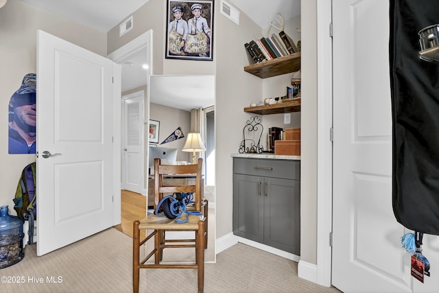 corridor with light colored carpet and baseboards