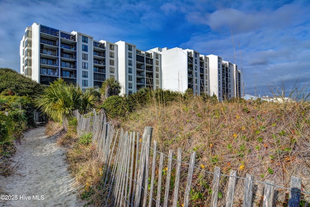 view of apartment building / complex featuring fence