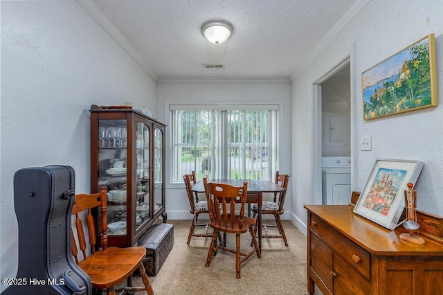 4512 Rivershore Dr, New Bern, NC 28560 - dining room featuring washer / dryer, a textured ceiling, light colored carpet, crown molding, and baseboards