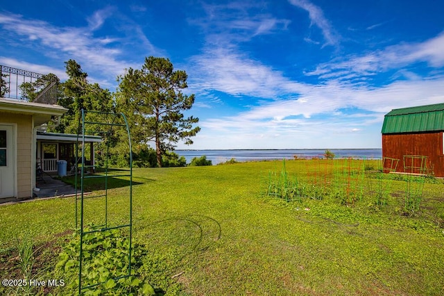 4512 Rivershore Dr, New Bern, NC 28560 - view of grassy yard with a water view, a barn, and an outbuilding