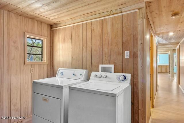 660 Beachview Dr SE, Bolivia, NC 28422 - washroom with wooden ceiling, separate washer and dryer, wooden walls, and light wood-style flooring