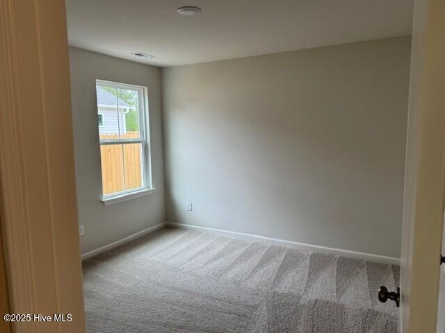 1120 Goldsboro Rd, Boiling Spring Lakes, NC 28461 - carpeted spare room with baseboards