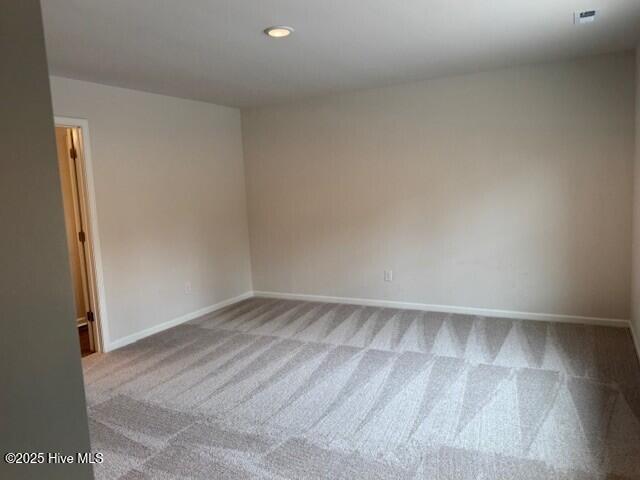1120 Goldsboro Rd, Boiling Spring Lakes, NC 28461 - carpeted spare room featuring baseboards and recessed lighting