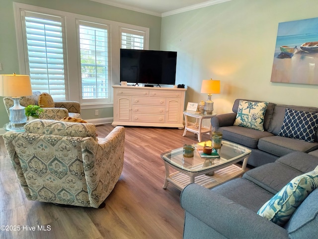 living room featuring crown molding, wood finished floors, healthy amount of natural light, and baseboards