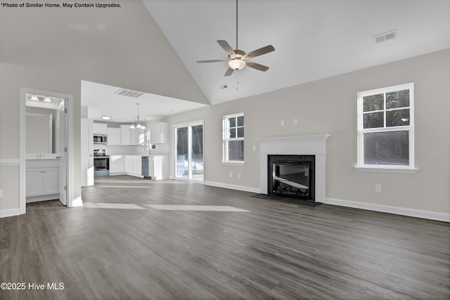 157 Tides End Dr, Holly Ridge, NC 28445 - unfurnished living room with a fireplace, a ceiling fan, dark wood-type flooring, high vaulted ceiling, and baseboards