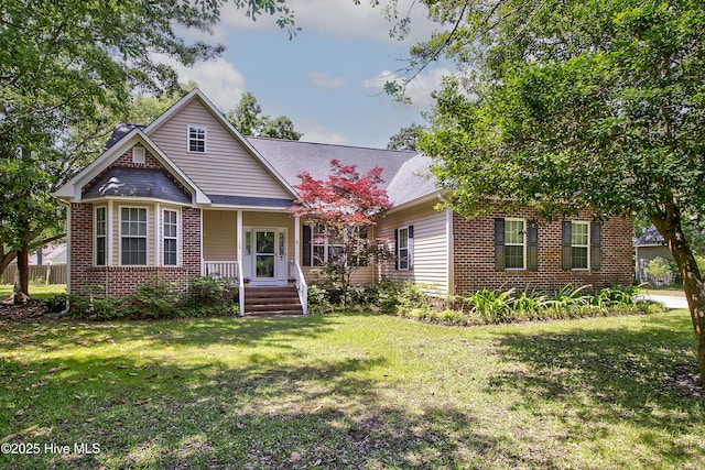 203 Abbey Ln, Wilmington, NC 28411 - view of front facade featuring covered porch, brick siding, and a front lawn