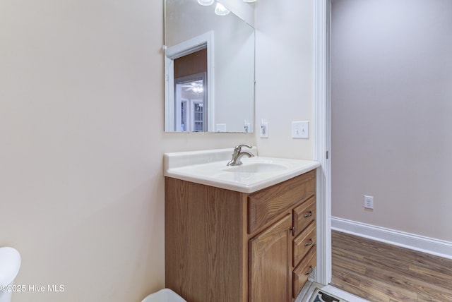 203 Abbey Ln, Wilmington, NC 28411 - bathroom featuring vanity, toilet, baseboards, and wood finished floors