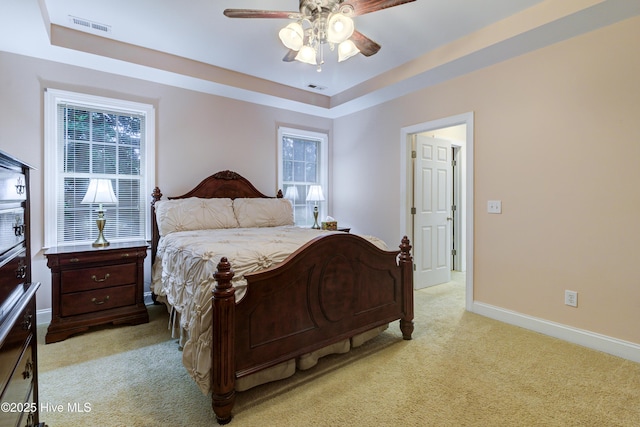 203 Abbey Ln, Wilmington, NC 28411 - bedroom with light carpet, baseboards, a tray ceiling, and a ceiling fan