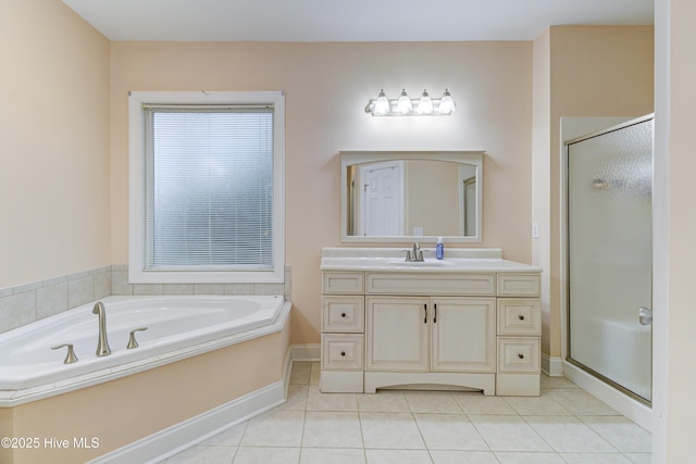 203 Abbey Ln, Wilmington, NC 28411 - bathroom with tile patterned floors, a shower stall, vanity, a garden tub, and baseboards