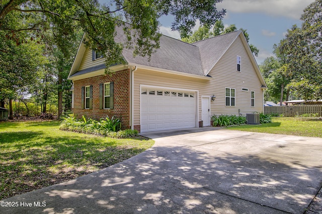 203 Abbey Ln, Wilmington, NC 28411 - view of side of property with roof with shingles, cooling unit, brick siding, an attached garage, and concrete driveway
