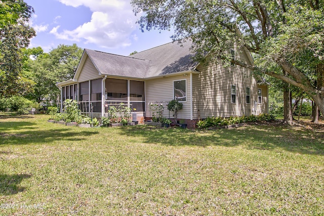 203 Abbey Ln, Wilmington, NC 28411 - back of house with a sunroom, a shingled roof, and a yard