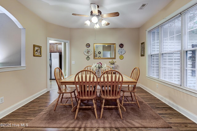 203 Abbey Ln, Wilmington, NC 28411 - dining space with dark wood-type flooring, healthy amount of natural light, arched walkways, and baseboards