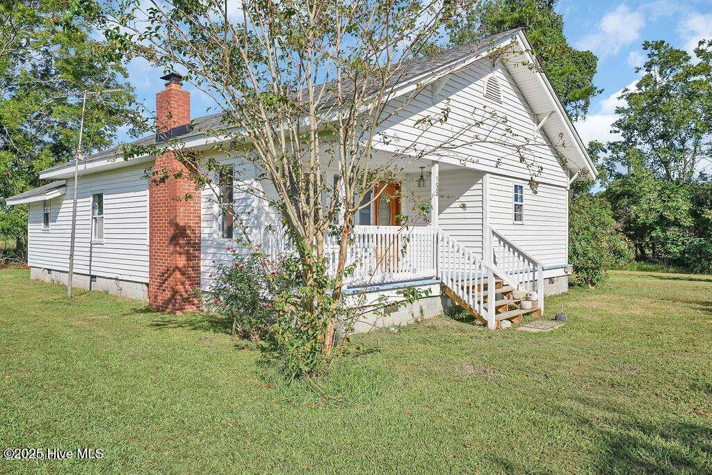 159 Shady Lane Rd, Willard, NC 28478 - back of property with a chimney, crawl space, a lawn, and a porch