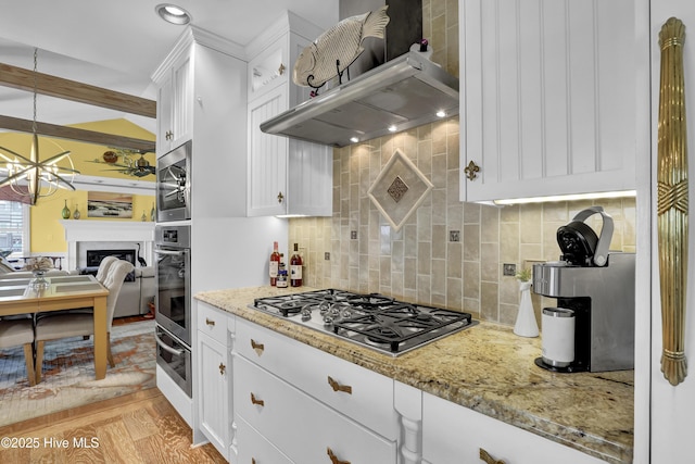 53 N Ridge Ln, Surf City, NC 28445 - kitchen featuring stainless steel appliances, a warming drawer, white cabinets, and decorative backsplash