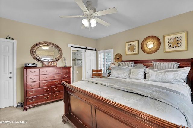 53 N Ridge Ln, Surf City, NC 28445 - bedroom featuring light colored carpet, a barn door, and a ceiling fan