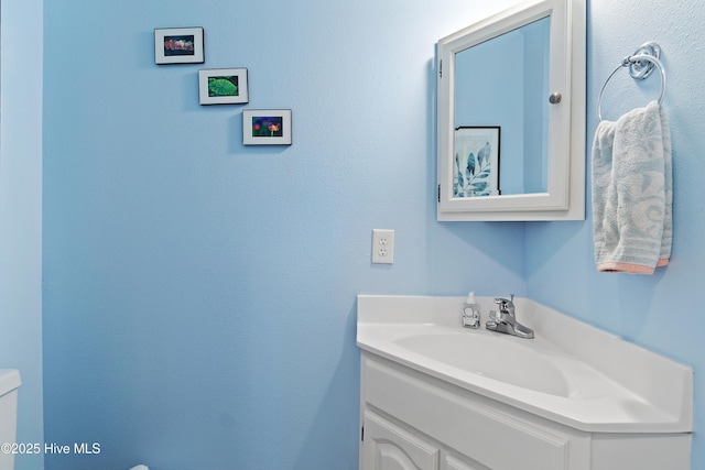 bathroom with toilet and vanity