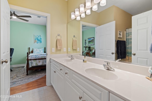full bathroom with connected bathroom, a ceiling fan, double vanity, and tile patterned flooring