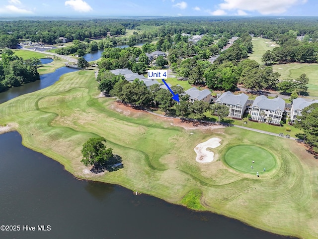 view of property location featuring a local golf course, a nearby body of water, and nearby suburban area