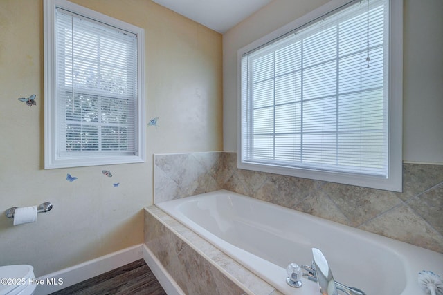 176 Lewis Rd, Hampstead, NC 28443 - bathroom featuring a garden tub, baseboards, and toilet