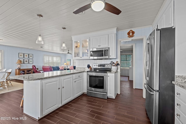 5709 Ocean Dr, Emerald Isle, NC 28594 - kitchen featuring appliances with stainless steel finishes, a peninsula, white cabinetry, glass insert cabinets, and ceiling fan