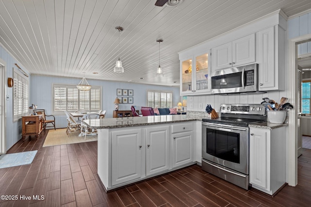 5709 Ocean Dr, Emerald Isle, NC 28594 - kitchen with stainless steel appliances, wood ceiling, a peninsula, plenty of natural light, and white cabinets