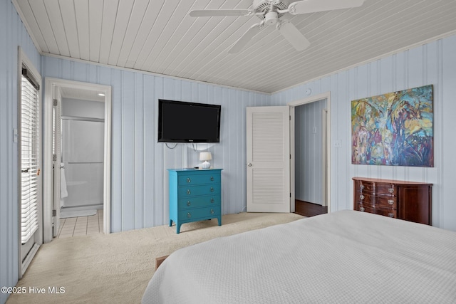 5709 Ocean Dr, Emerald Isle, NC 28594 - carpeted bedroom with wood ceiling, a ceiling fan, and ensuite bath