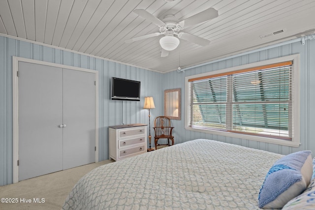 5709 Ocean Dr, Emerald Isle, NC 28594 - bedroom featuring carpet floors, ornamental molding, a ceiling fan, wood ceiling, and a closet