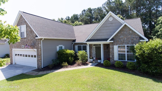 view of front of home featuring stone siding, a front lawn, roof with shingles, and concrete driveway
