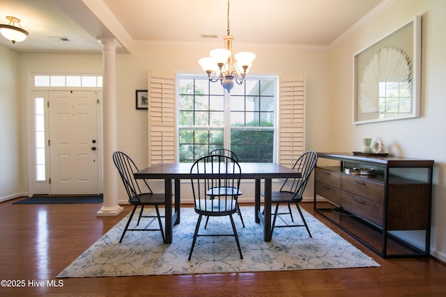 dining room with a chandelier, healthy amount of natural light, dark wood-style flooring, and ornamental molding
