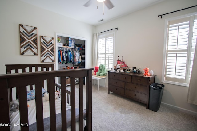 carpeted bedroom featuring a closet and a ceiling fan