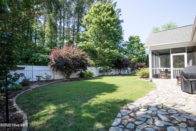 view of yard with a sunroom and a patio