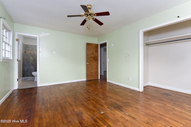 514 Mohican Trl, Wilmington, NC 28409 - unfurnished bedroom with wood finished floors, a closet, baseboards, and connected bathroom
