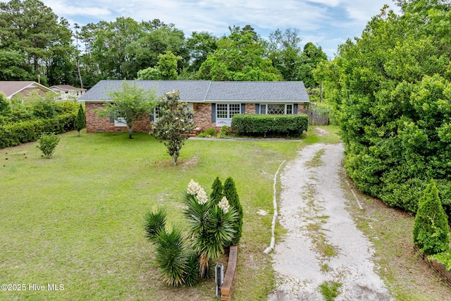 514 Mohican Trl, Wilmington, NC 28409 - ranch-style house featuring driveway, a front lawn, brick siding, and roof with shingles