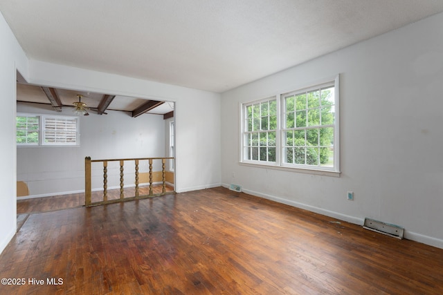 514 Mohican Trl, Wilmington, NC 28409 - spare room featuring wood-type flooring, beam ceiling, plenty of natural light, and baseboards