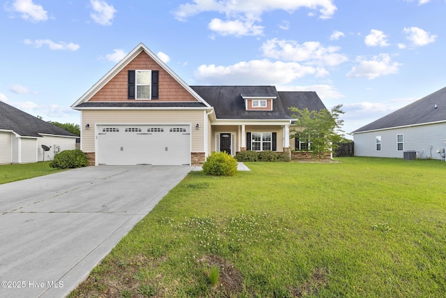 craftsman inspired home with driveway, a front lawn, and central air condition unit