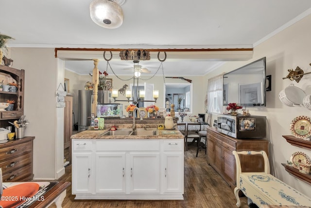 2601 Mayberry Loop Rd, Morehead City, NC 28557 - kitchen with a sink, ornamental molding, white cabinets, dark wood finished floors, and stainless steel microwave