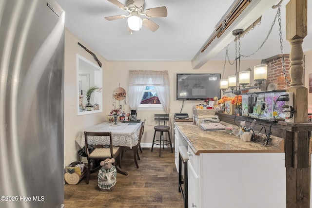 2601 Mayberry Loop Rd, Morehead City, NC 28557 - kitchen with freestanding refrigerator, dark wood-type flooring, ceiling fan, white cabinets, and hanging light fixtures
