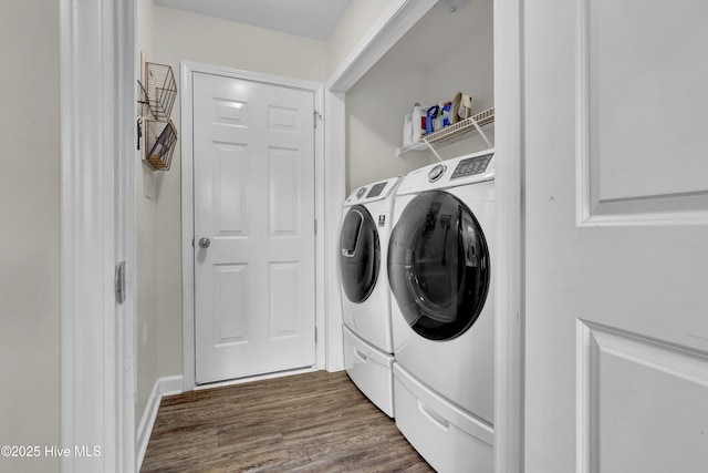 laundry area with washer and dryer and dark wood-type flooring
