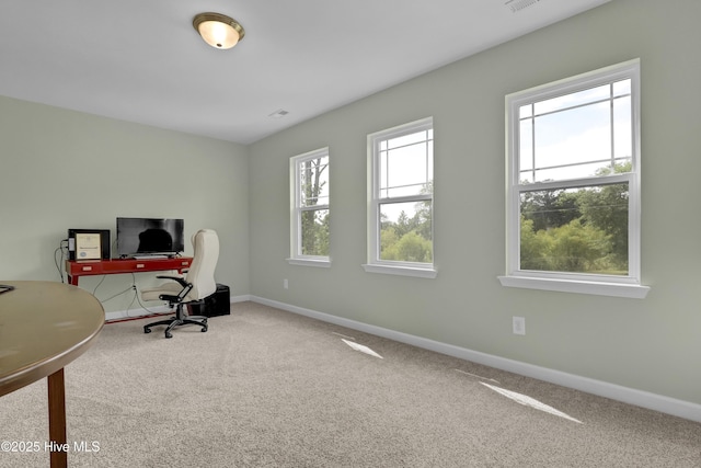 carpeted office space featuring baseboards