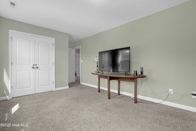 unfurnished living room with carpet floors and baseboards