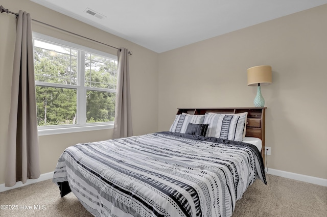 bedroom with carpet and baseboards