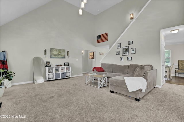 living area with carpet flooring, high vaulted ceiling, and baseboards