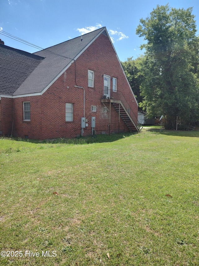 403 S William St, Goldsboro, NC 27530 - view of property exterior featuring brick siding, a yard, and stairs