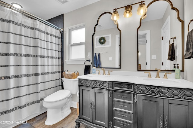 3446 Constable Way, Wilmington, NC 28405 - bathroom featuring double vanity, toilet, wood finished floors, and a shower with curtain